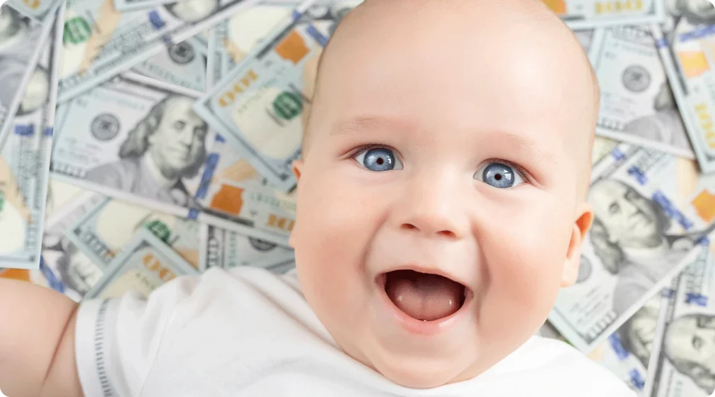 happy baby with a bed of money
